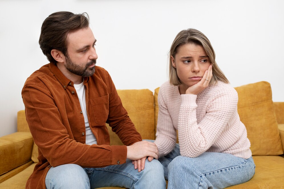 medium-shot-sad-couple-couch_23-2149308842
